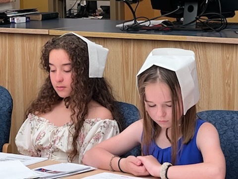 girls at a table reading